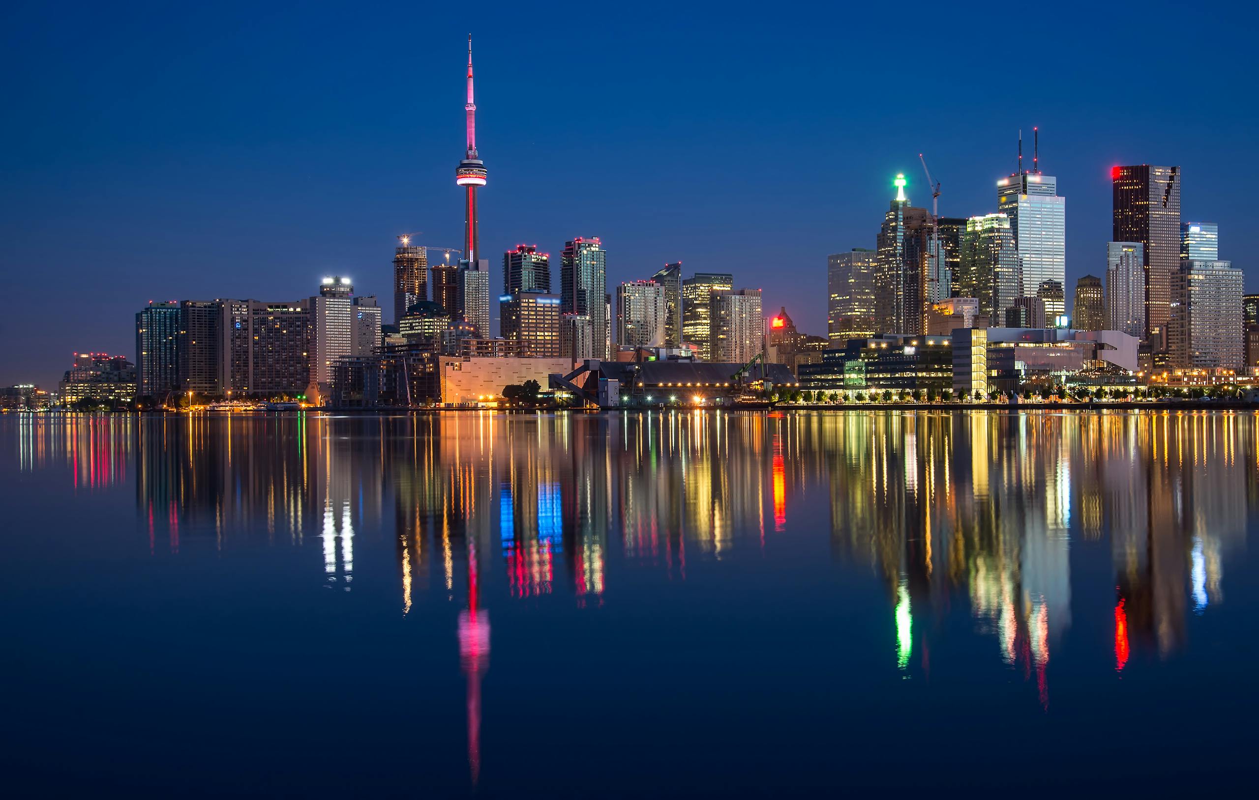 Buildings Near Body Of Water At Night